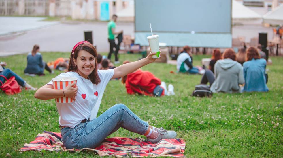 Woman excited watching outdoor movie